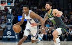 Kings guard De’Aaron Fox dribbled past Wolves guard Austin Rivers in the third quarter of Saturday night’s game at Target Center. The teams meet a