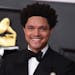 FILE - Trevor Noah appears at the 63rd annual Grammy Awards in Los Angeles on March 14, 2021. Noah is hosting the Grammy Awards for a third-straight y
