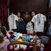 Melanie Rolo Gonzalez, right, and her sister Merlyn, pose for a photo with their medical student uniforms as they pack supplies for their journey to t