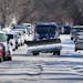 A snow plow navigates crowded, snow and ice covered Charles Ave. near Grotto St. N. Monday, Jan. 30, 2023 in St. Paul, Minn.
