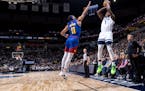 Wolves guard Anthony Edwards fired up a three-point over the Nuggets’ Bruce Brown in an early January game. The Wolves’ three-point shooting has b