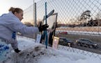 Marsha Gayton placed a cross at the accident site where her son was killed during a vigil Monday, Jan. 30, 2023, in Bloomington, Minn. Donald E. Gayto