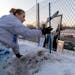 Marsha Gayton placed a cross at the accident site where her son was killed during a vigil Monday, Jan. 30, 2023, in Bloomington, Minn. Donald E. Gayto