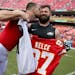 Kansas City Chiefs tight end Travis Kelce, left, plants a kiss on the cheek of his brother, Philadelphia Eagles center Jason Kelce as they exchanged j