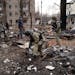 Ukrainian security forces comb through debris shortly after a strike at a residential building in Konstantanivka, Ukraine on Saturday, Jan. 28, 2023. 