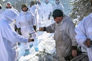 Minnesota National Guard soldiers and airmen share a hot beverage with Norwegian Home Guard Soldiers in Haltdalen, Norway last March during a five-day