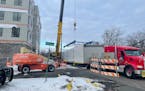 A 68-foot module, containing portions of two apartments, is lifted off a flatbed at Pentagon Village in Edina. The module arrived from the Rise Modula