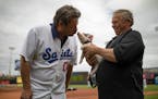 Each year Dennis Hauth, with Porknite in 2018, trains the St. Paul Saints mascot. Here Porknite gives PA announcer Lee Adams a smooch.