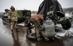 Ukrainian soldiers changed the tire on a trailer carrying an anti-aircraft gun along the road to Bahkmut, in the Donbas region of eastern Ukraine on W