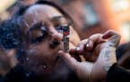 A customer smokes cannabis outside a cannabis dispensary on Jan. 24 in New York. 