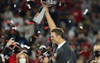 Tom Brady hoists the Vince Lombardi Trophy after winning Super Bowl LV with Tampa Bay in 2021.