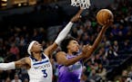 Wolves forward Jaden McDaniels, shown guarding Jazz guard Collin Sexton in a Jan. 16 game, is being touted by teammates to be included on the NBA’s 