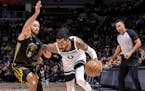 Stephen Curry (30) of the Golden State Warriors defends D'Angelo Russell (0) of the Minnesota Timberwolves in the first quarter Wednesday, February 1,