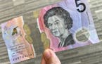 This photo illustration taken in Hong Kong on Thursday, Feb. 2, 2023, shows the Australian $5 banknote. Australia’s central bank announced it will e