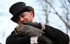 Groundhog Club handler A.J. Dereume holds Punxsutawney Phil, the weather prognosticating groundhog, during the 137th celebration of Groundhog Day on G