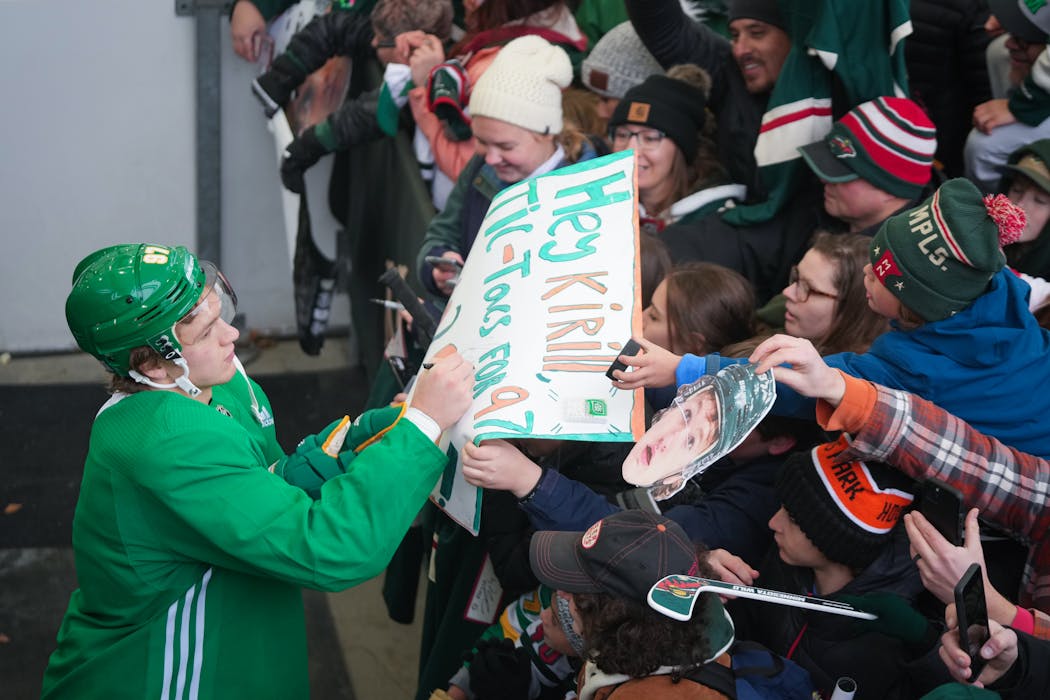 Kirill Kaprizov autographed a sign for a fan during the Wild’s outdoor practice Nov. 5 in St. Louis Park.