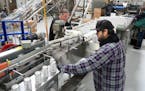Packing line operator Christopher Coughlin works quality control as Clr!ty THC infused seltzers were canned last February at the Fulton production bre