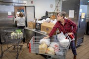 Beth O’Connor, a retired library employee, right, and Kathy Moore, a retired nurse, packaged groceries Thursday for Keystone Community Partners in S