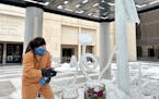 Artist Andrew Bentley creates ice flower sculptures outside the Minneapolis Institute of Art on Friday. 