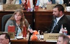 South Dakota Republican state Sens. Julie Frye-Mueller, left, and Tom Pischke listen on the Senate floor in the state Capitol in Pierre, S.D., on Wedn