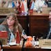 South Dakota Republican state Sens. Julie Frye-Mueller, left, and Tom Pischke listen on the Senate floor in the state Capitol in Pierre, S.D., on Wedn