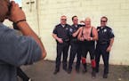 Kenny “The Sodbuster” Jay posed for photos in 1998 with officers who adored the wrestler in West St. Paul.