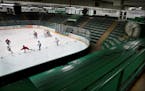 Surrounded by old, wooden bleachers, Breakaway Academy 5th graders practice hockey in the West rink at the City of Edina's aged Braemar Arena-- the ki