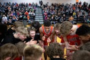 Cherry’s Isaac Asuma, center, cheers in the huddle with teammates before playing Fosston Friday, Jan. 27, 2023 at Cherry High School in Cherry, Minn