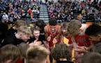 Cherry’s Isaac Asuma, center, cheers in the huddle with teammates before playing Fosston Friday, Jan. 27, 2023 at Cherry High School in Cherry, Minn