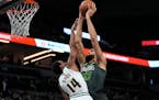 Timberwolves center Rudy Gobert dunks on Nuggets reserve point guard Ish Smith.