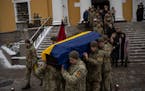 Soldiers carry the coffin of Eduard Strauss, a Ukrainian serviceman who died in combat on Jan. 17 in Bakhmut, during a farewell ceremony in Kyiv, Ukra