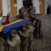 Soldiers carry the coffin of Eduard Strauss, a Ukrainian serviceman who died in combat on Jan. 17 in Bakhmut, during a farewell ceremony in Kyiv, Ukra