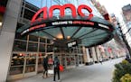 FILE - People walk by the AMC 34th Street theater on March 5, 2021, in New York. AMC Theaters, the nation’s largest movie theater chain, on Monday u