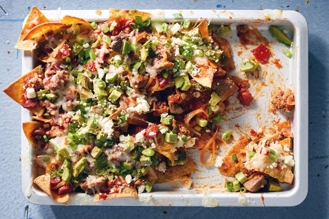 At the heart of these nachos is a hearty filling made with beef and bacon.