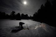 Under the moonlight, Anoka High School senior Hayden Ceaser emerged Monday morning after sleeping overnight in a quinzhee, or snow shelter, they’d b