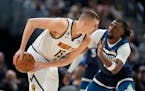 Nuggets center Nikola Jokic was defended by Timberwolves center Naz Reid in the first half Tuesday. Jokic finished with a triple-double of 20 points, 