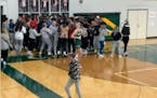 Fans celebrated the game-winning shot by Patrick Rowe of Chisago Lakes.