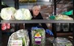 Volunteer Deb Gallagher filled the shelves of the cooler at Open Door Pantry in Eagan on Wednesday.
