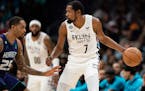 Kevin Durant (7) of the Brooklyn Nets is guarded by P.J. Washington (25) of the Charlotte Hornets in the third quarter during their game at Spectrum C