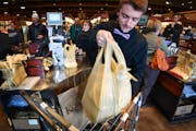 Alec Voight bagged groceries at Kowalski’s in southwest Minneapolis 2017. Kowalski’s customers are given a choice of paper or plastic grocery bags