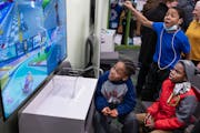 Ten-year-old Amere, left and holding the controller, played a video games with friends at the new Spark’d Studios at Harrison Recreation Center Thur