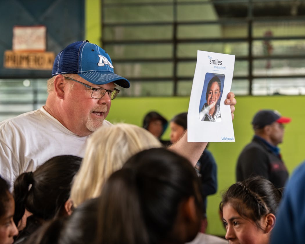 David Law, Minnetonka Schools superintendent, handed out a student photo package.