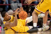The Gophers’ Ta’Lon Cooper fell for a loose ball in the first half against Iowa on Sunday at Williams Arena.