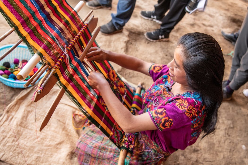 A local woman weaved a vibrant textile.