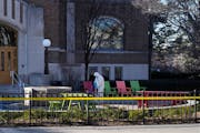 A worker cleaned up outside Berkey Hall at Michigan State University on Tuesday, one day after a shooting on campus left three students dead.