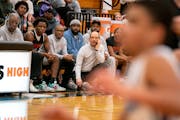 Coach Joe Hyser, with his team and coaches, kept an eye on the progress of the Minneapolis South boys basketball team. Eight players transferred from 