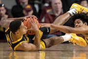 Gophers freshman Jaden Henley, right, battled Iowa’s Kris Murray for a loose ball in Minnesota’s last game, a 68-56 defeat for the Gophers last Su