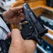 A customer checked out a handgun for sale in Hempstead, N.Y., in June 2022. 