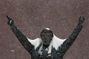 The statue of famed hockey coach Herb Brooks that stands outside Xcel Energy Center caught some snow in 2010 and is in the way of a large snowstorm th