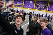 Minnesota Vikings fullback C.J. Ham (30) poses for selfies as he and guard Chris Reed (62) warm up ahead of a track and field competition Saturday, Ja